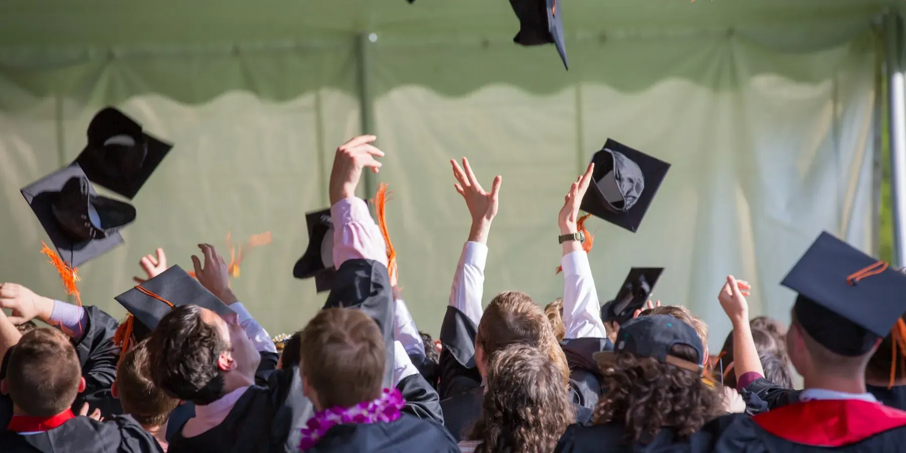 Graduates throwing their caps in the air at a commencement ceremony