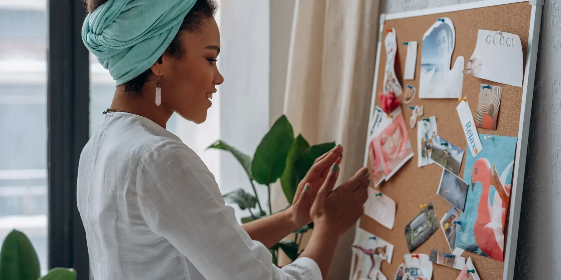 A designer pinning ideas and clippings to an inspiration board