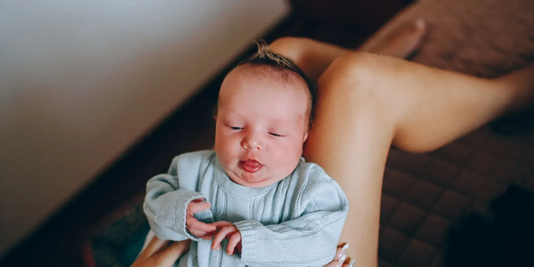 A newborn resting in a parent’s arms
