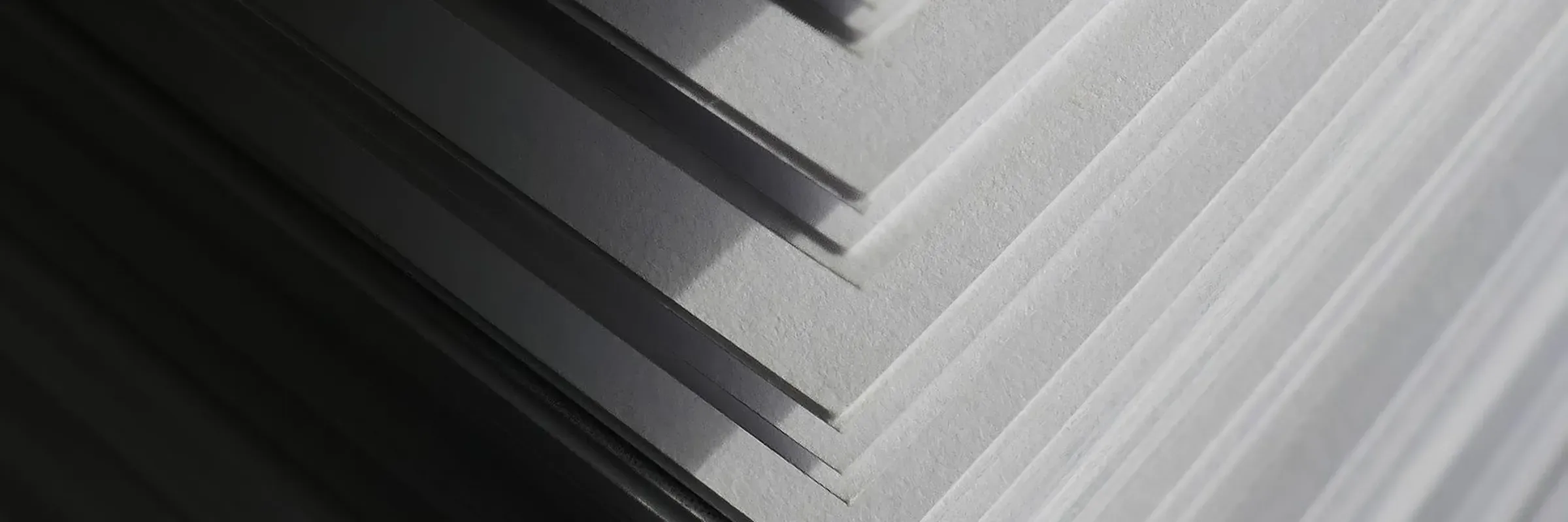 Cut sheets of paper stacked in shallow, angled layers
