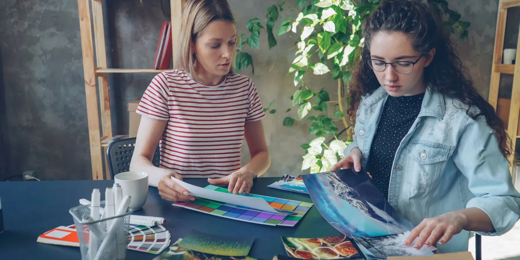 Two people reviewing printed samples and colour proofs together