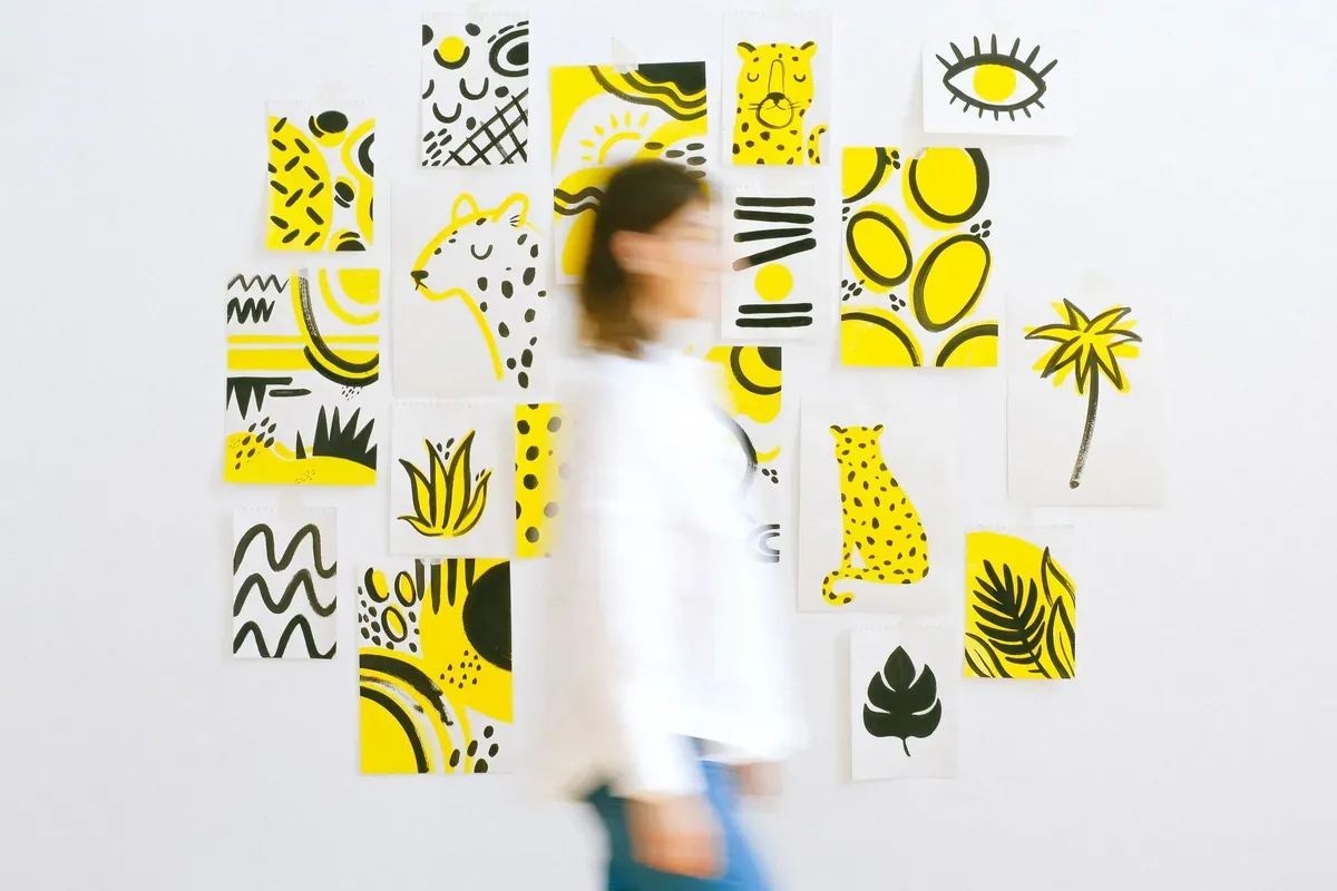 A wall of bright yellow art posters