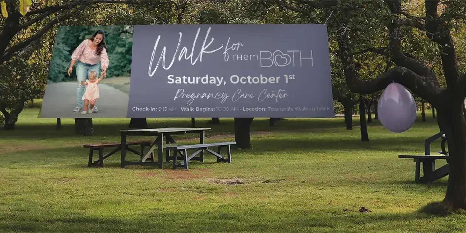 A Walk for Life outdoor banner mounted on posts at a park