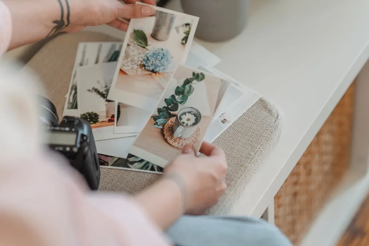 Reviewing warm printed photographs at a table