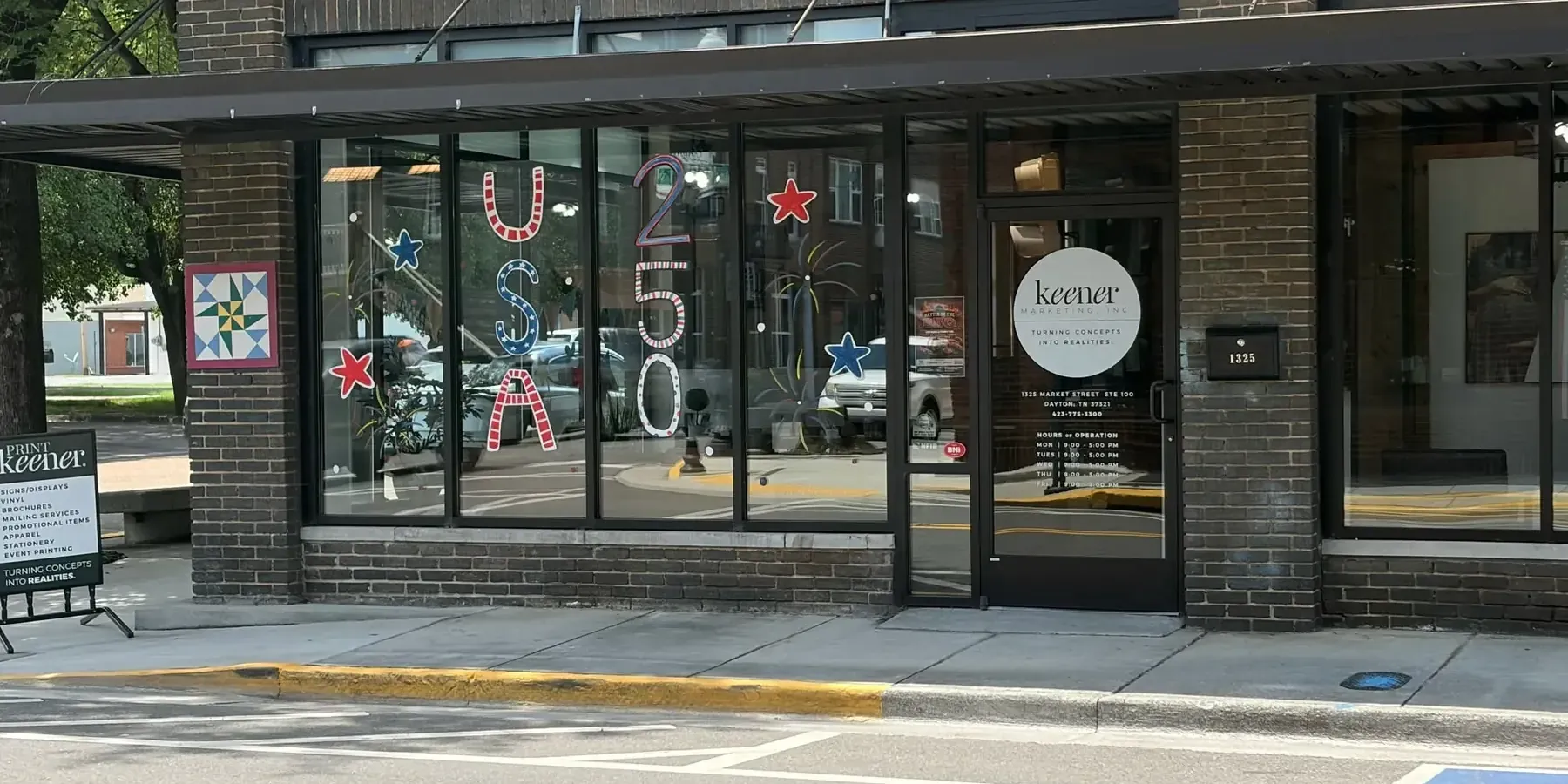 The front door of the Keener Marketing office, with the business hours posted