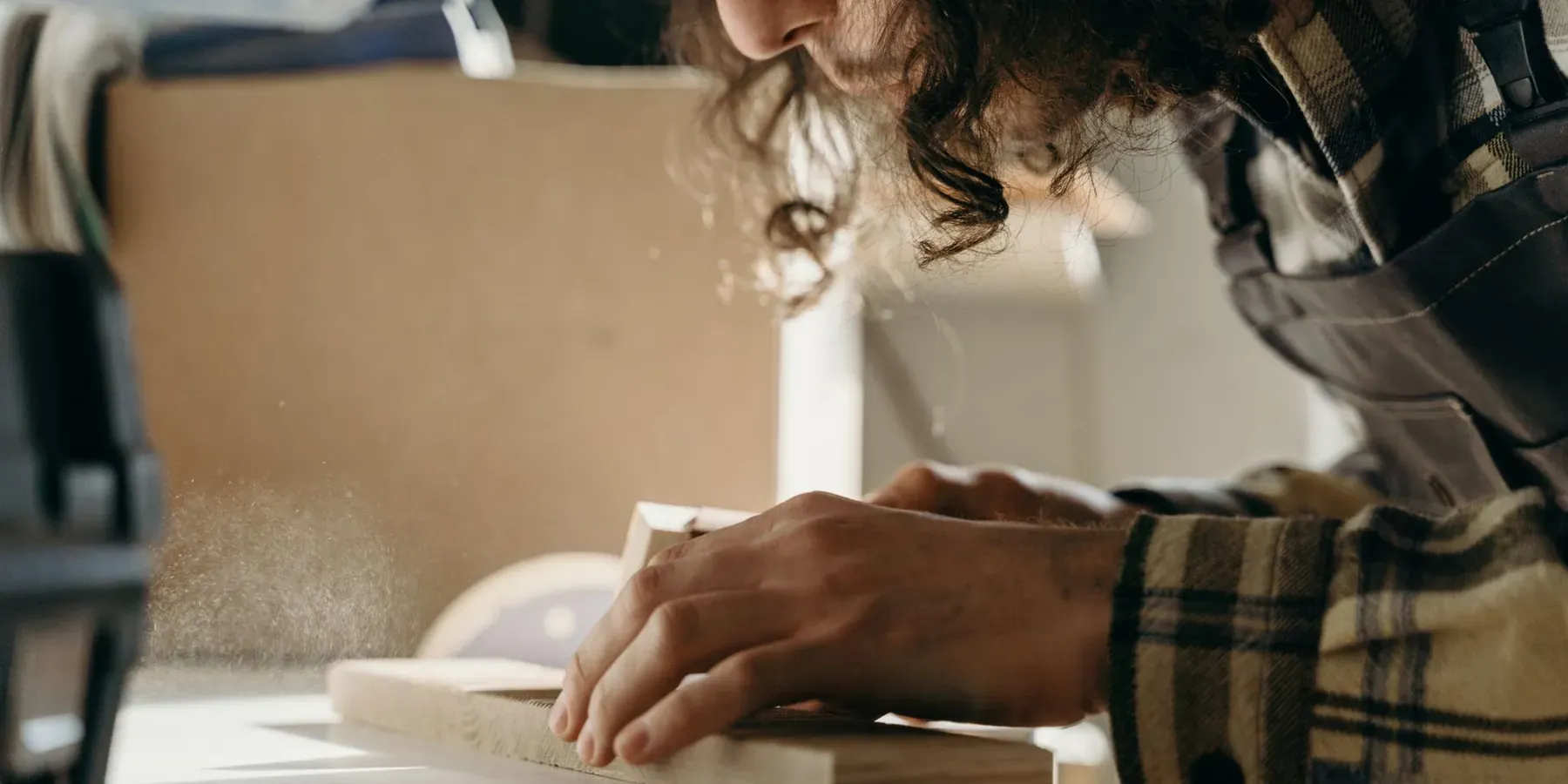 A maker working by hand on a custom project at a workbench