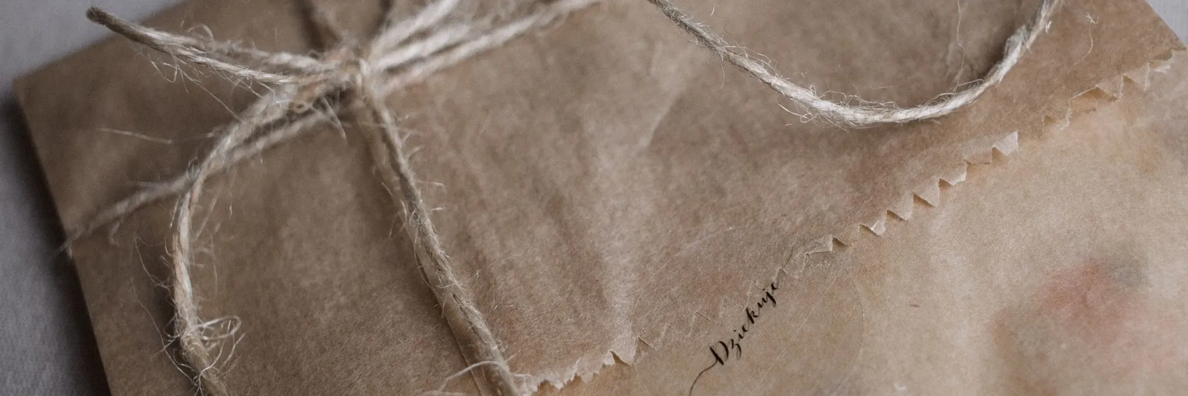 A parcel wrapped in kraft paper and tied with string
